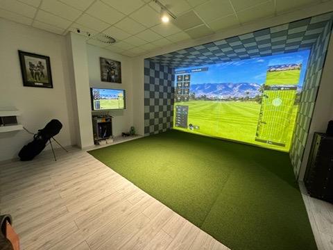 Bright studio build — turf, screen wall and lounge corner.