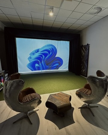 Boutique lounge setup with designer seating around the tee.