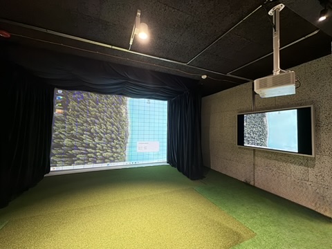 Acoustic-treated room with blackout curtains and second display.